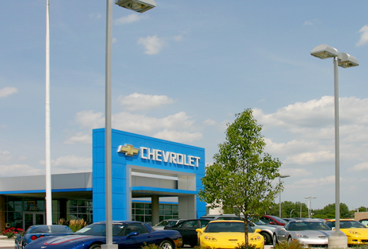 Chevrolet cars parked at the exterior of the building with a blue square archway