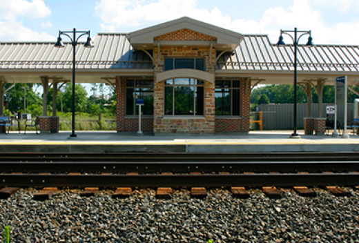 Newly constructed brick commuter station as seen from tracks.