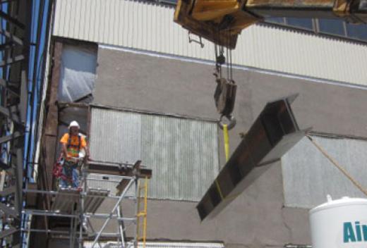 Metal siding is being installed on the maintenance building.