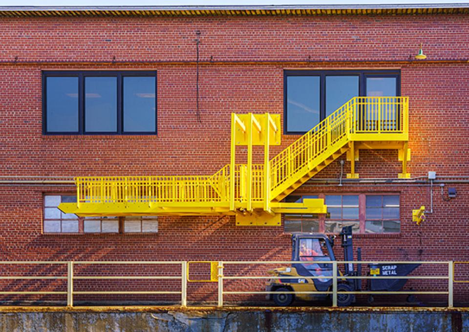 Safety ladder seen on exterior brick wall.