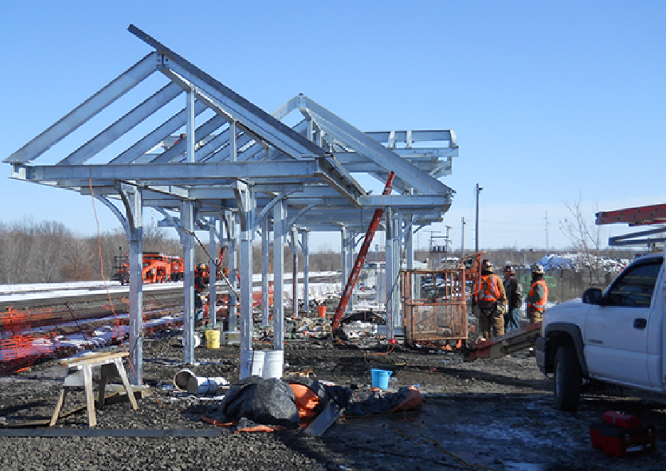 Construction begins showing the metal structure being erected.
