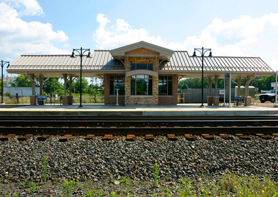 Newly constructed brick commuter station as seen from tracks.