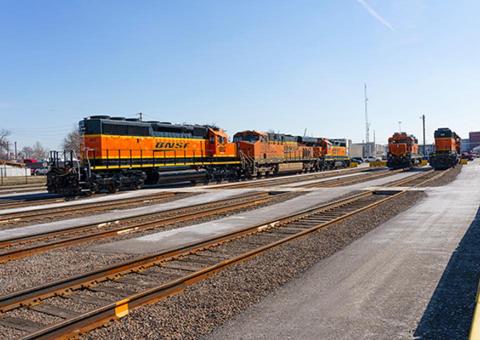 Train locomotive and cars moving to outbound storage tracks.