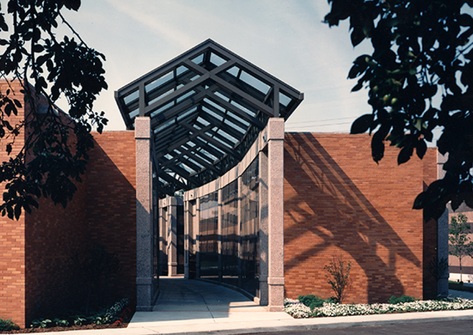 Exterior mausoleum entrance is made of brick and granite pillars.