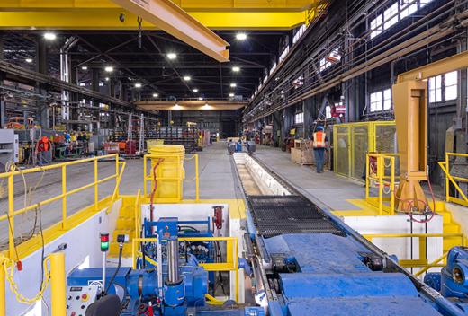 Maintenance building interior with view of blue wheel truing machine.