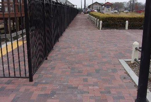 New brick pavement and fencing for station