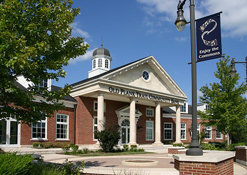 Colonial-style red brick exterior with concrete pillars