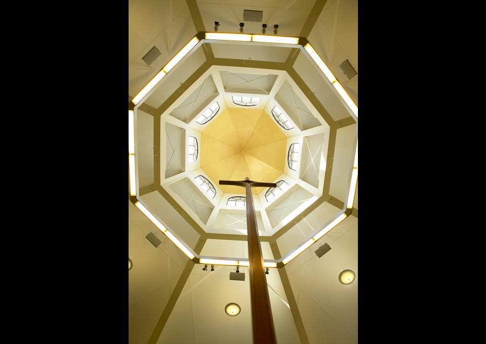 Octagonal skylight viewed from directly below, highlighting cross and arched windows.