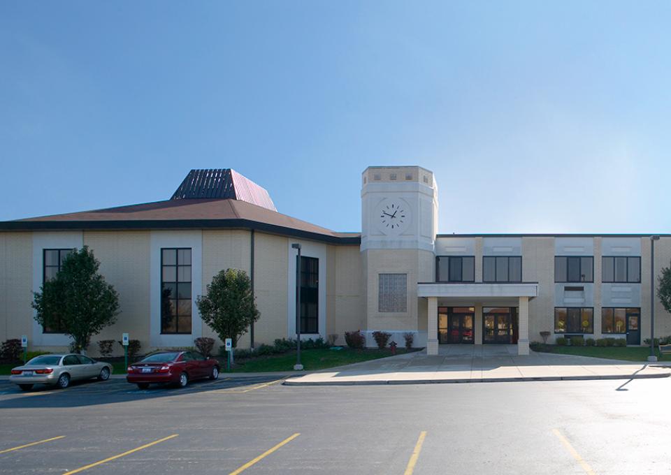 Yellow brick exterior with a clock tower.