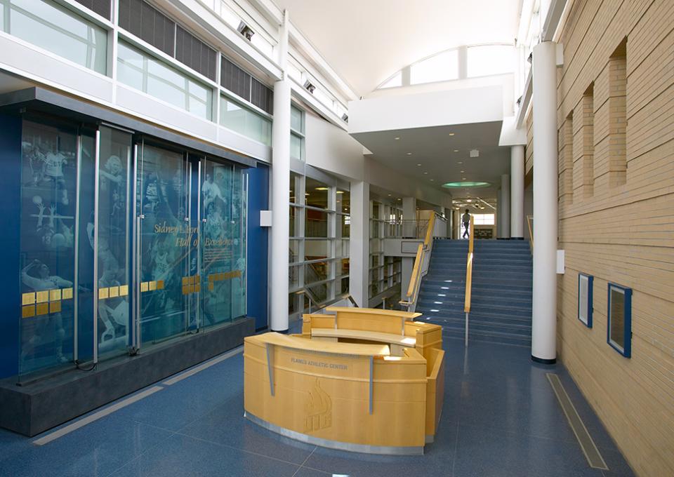 Breezeway with brick exterior, window display, and a help center desk in pine wood.