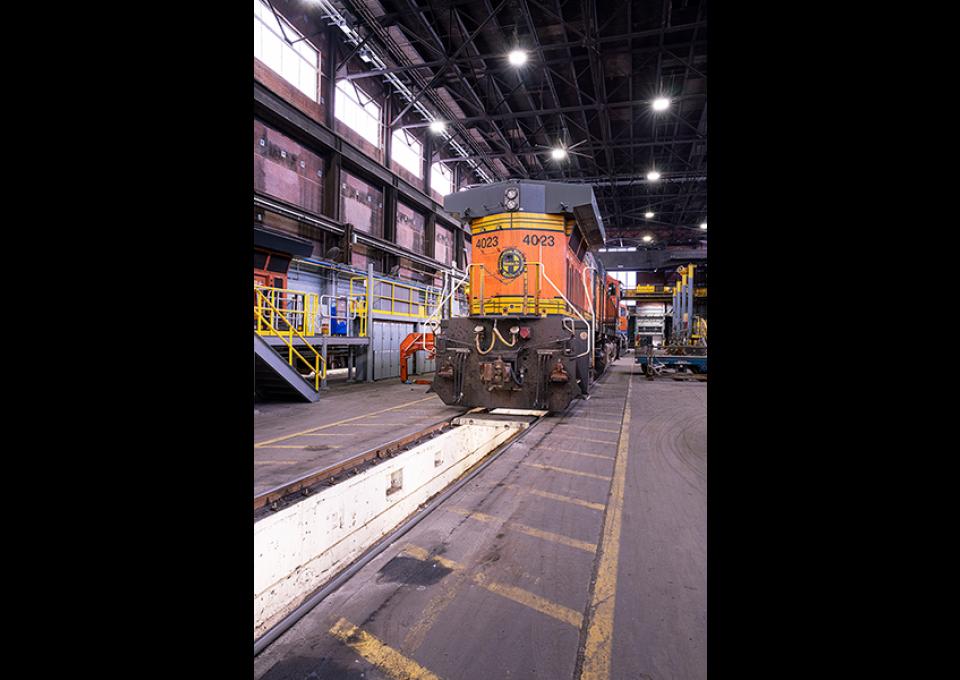 Interior maintenance building with a view of a train car.
