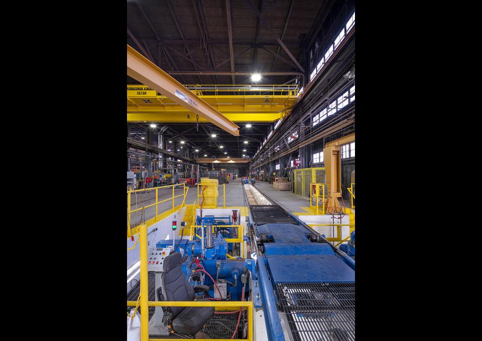 Maintenance building interior with view of blue wheel truing machine and drop table.