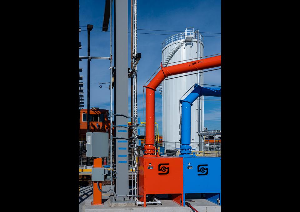 Close-up of fueling and maintenance equipment with fuel tank in background.