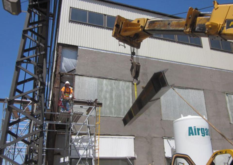 Metal siding is being installed on the maintenance building.